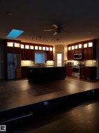 Kitchen with glass insert cabinets, appliances with stainless steel finishes, and tasteful backsplash - 