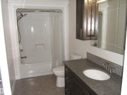 Full bathroom featuring shower / tub combo and vanity - 