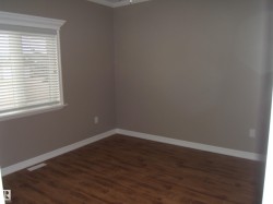 Unfurnished room featuring dark wood-style flooring and ornamental molding - 