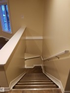 Stairs featuring baseboards and tile patterned floors - 