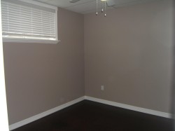Empty room featuring ceiling fan and a drop ceiling - 