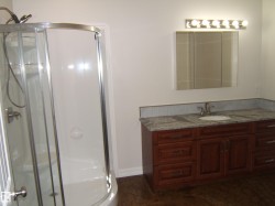 Full bathroom featuring a shower stall and vanity - 
