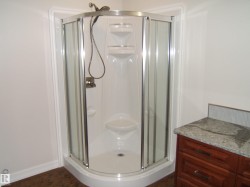 Bathroom with a shower stall and baseboards - 