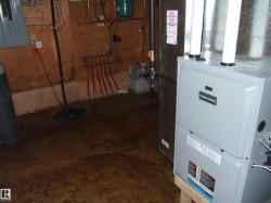 Utility room with electric panel, heating unit, and drainage system - 