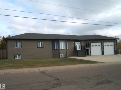 Ranch-style house with driveway, an attached garage, and a front yard - 