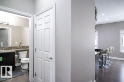Half bathroom featuring dark wood finished floors, vanity, a textured ceiling, and recessed lighting - 