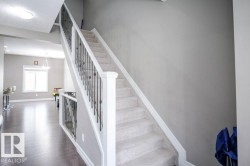 Stairs with a textured ceiling and wood finished floors - 