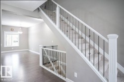 Stairs with a textured ceiling and wood finished floors - 