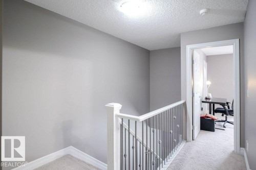 Hallway featuring carpet, an upstairs landing, an office area, and a textured ceiling - 97 2003 Rabbit Hill Road, Edmonton, AB - Indoor Photo Showing Other Room
