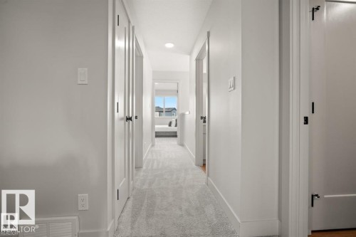 Corridor with light colored carpet and recessed lighting - 24 Grayson Green, Stony Plain, AB - Indoor Photo Showing Other Room