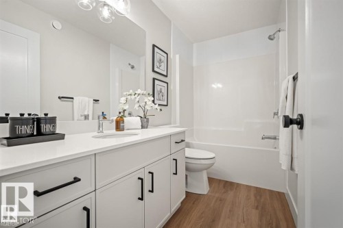 Bathroom featuring vanity, washtub / shower combination, and dark wood finished floors - 24 Grayson Green, Stony Plain, AB - Indoor Photo Showing Bathroom