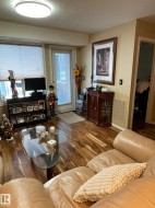 Living area featuring wood finished floors and a textured ceiling - 