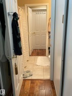 Hall with light wood-style floors - 