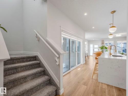 Staircase with wood finished floors and recessed lighting - 4447 Kinsella Green, Edmonton, AB - Indoor Photo Showing Other Room