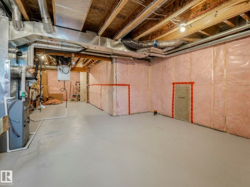 Unfinished below grade area featuring heating unit - 4447 Kinsella Green, Edmonton, AB - Indoor Photo Showing Basement