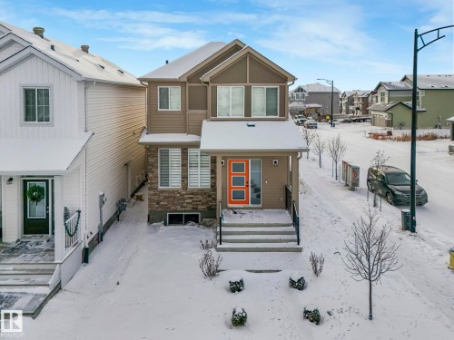 View of front facade with stone siding and a residential view - 4447 Kinsella Green, Edmonton, AB - Outdoor
