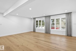 Empty room with light wood-style flooring and recessed lighting - 