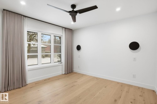 Unfurnished room with light wood-style flooring, ceiling fan, and recessed lighting - 14604 Mackenzie Drive, Edmonton, AB - Indoor Photo Showing Other Room