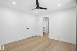 Unfurnished bedroom featuring a spacious closet, light wood-style flooring, a ceiling fan, and recessed lighting - 