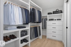 Spacious closet with light wood-style flooring - 