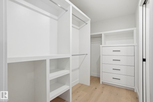 Spacious closet featuring light wood-style floors - 14604 Mackenzie Drive, Edmonton, AB - Indoor With Storage