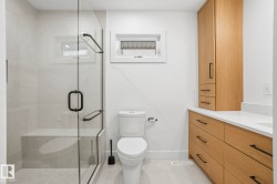 Bathroom featuring vanity, a stall shower, and light tile patterned floors - 