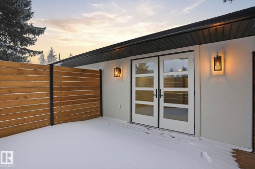 Patio terrace at dusk featuring french doors and a wooden deck - 14604 Mackenzie Drive, Edmonton, AB - Outdoor With Exterior