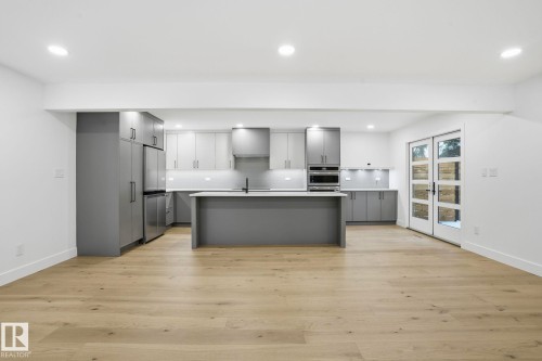 Kitchen featuring gray cabinets, light countertops, a center island with sink, modern cabinets, and recessed lighting - 14604 Mackenzie Drive, Edmonton, AB - Indoor Photo Showing Kitchen