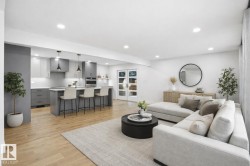 Living area with light wood-type flooring and recessed lighting - 
