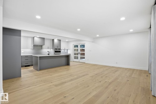 Kitchen featuring gray cabinets, light countertops, a kitchen island with sink, light wood-style floors, and recessed lighting - 14604 Mackenzie Drive, Edmonton, AB - Indoor Photo Showing Kitchen