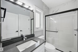 Bathroom with vanity and a stall shower - 