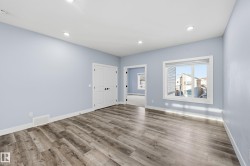 Empty room with wood finished floors and recessed lighting - 