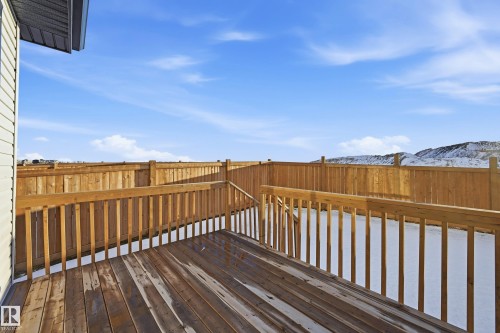 Wooden terrace featuring a mountain view - 829 Morris Avenue, Leduc, AB - Outdoor With Exterior