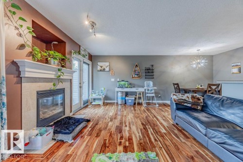 42 9511 102 Avenue, Morinville, AB - Indoor Photo Showing Living Room With Fireplace