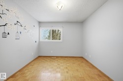 Spare room with a textured ceiling and baseboards - 