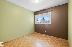 Unfurnished room with a textured ceiling and baseboards - 