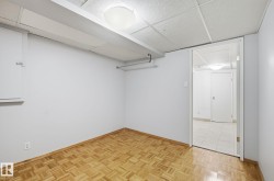 Finished basement with a paneled ceiling and baseboards - 