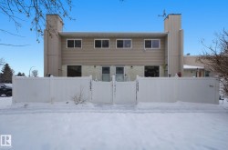 View of front of property featuring a chimney and a gate - 
