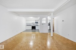 Unfurnished living room featuring beam ceiling and baseboards - 