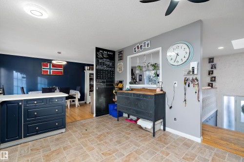 Kitchen with a skylight, a ceiling fan, a textured ceiling, and pendant lighting - 145 Plum Crescent, Wetaskiwin, AB - Indoor