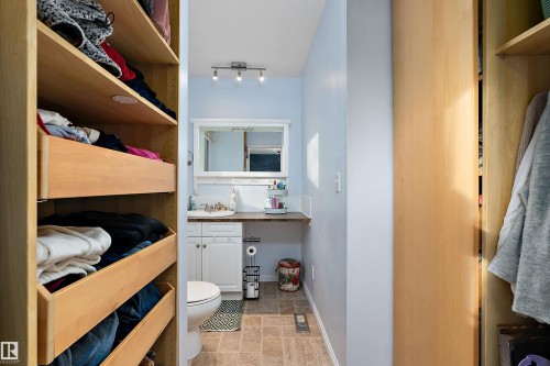 Bathroom featuring vanity and stone finish floors - 145 Plum Crescent, Wetaskiwin, AB - Indoor