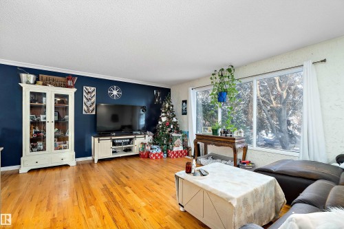 Living room with light wood-type flooring and a textured ceiling - 145 Plum Crescent, Wetaskiwin, AB - Indoor Photo Showing Living Room