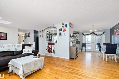 Living area featuring light wood finished floors and a textured ceiling - 145 Plum Crescent, Wetaskiwin, AB - Indoor Photo Showing Living Room