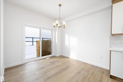 Unfurnished dining area with a chandelier and light wood-type flooring - 