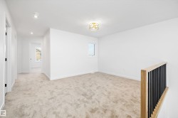 Spare room with light colored carpet and recessed lighting - 