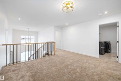 Empty room with a chandelier, independent washer and dryer, recessed lighting, and carpet - 