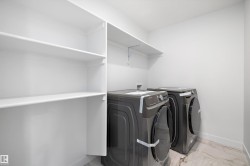Laundry area featuring light marble finish floors and washer and dryer - 