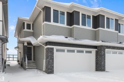 Contemporary home with an attached garage and stone siding - 