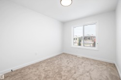 Carpeted empty room featuring baseboards - 