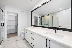 Full bath featuring a walk in closet, double vanity, light marble finish flooring, a marble finish shower, and recessed lighting - 